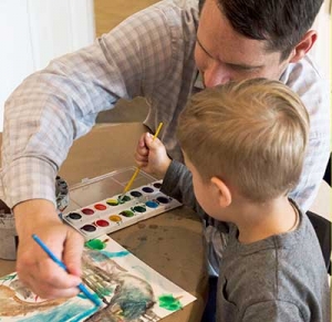 man and child painting