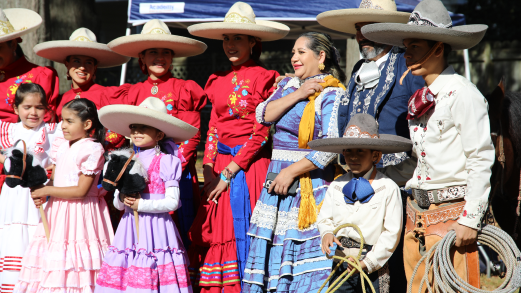 A group of adults and children wearing sombreros and holding lassos